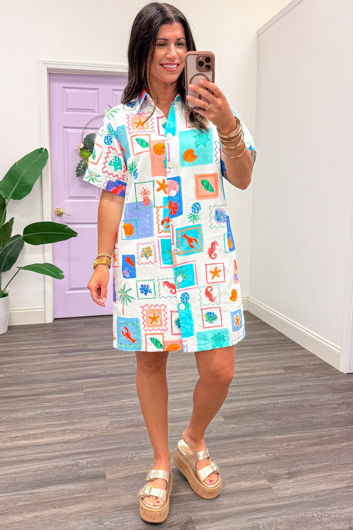 cream and blue with multicolored beach theme print short sleeve button front v neckline short dress