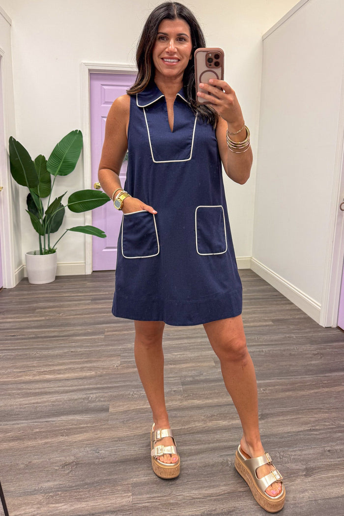 navy blue with cream trim sleeveless short dress with front patch pockets