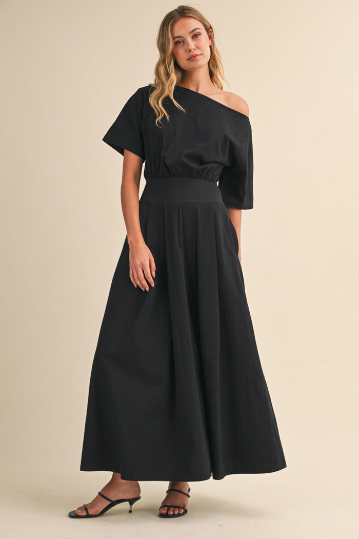 Black midi dress with boat neck and cinched waist by Klesis with a flowy skirt