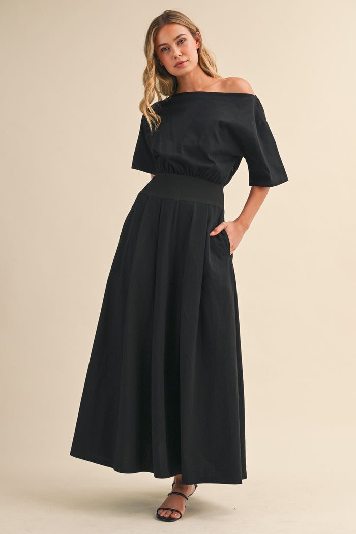 Black midi dress with boat neck and cinched waist by Klesis with convenient side pockets