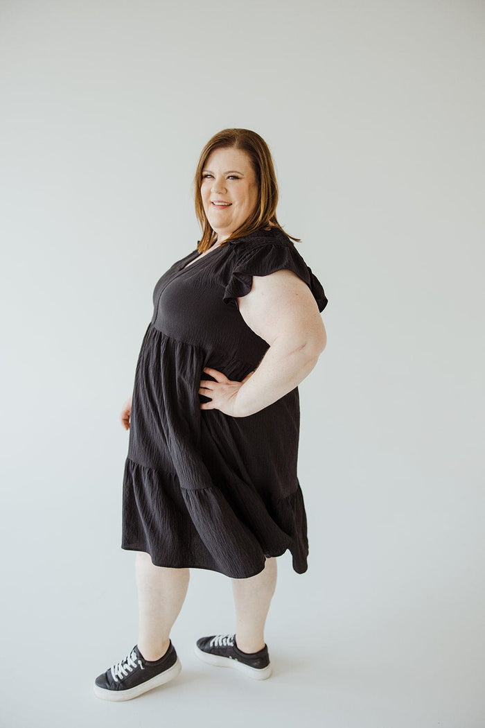 SOLID WOVEN TIERED DRESS WITH FLUTTER SLEEVE IN BLACK - Love Marlow